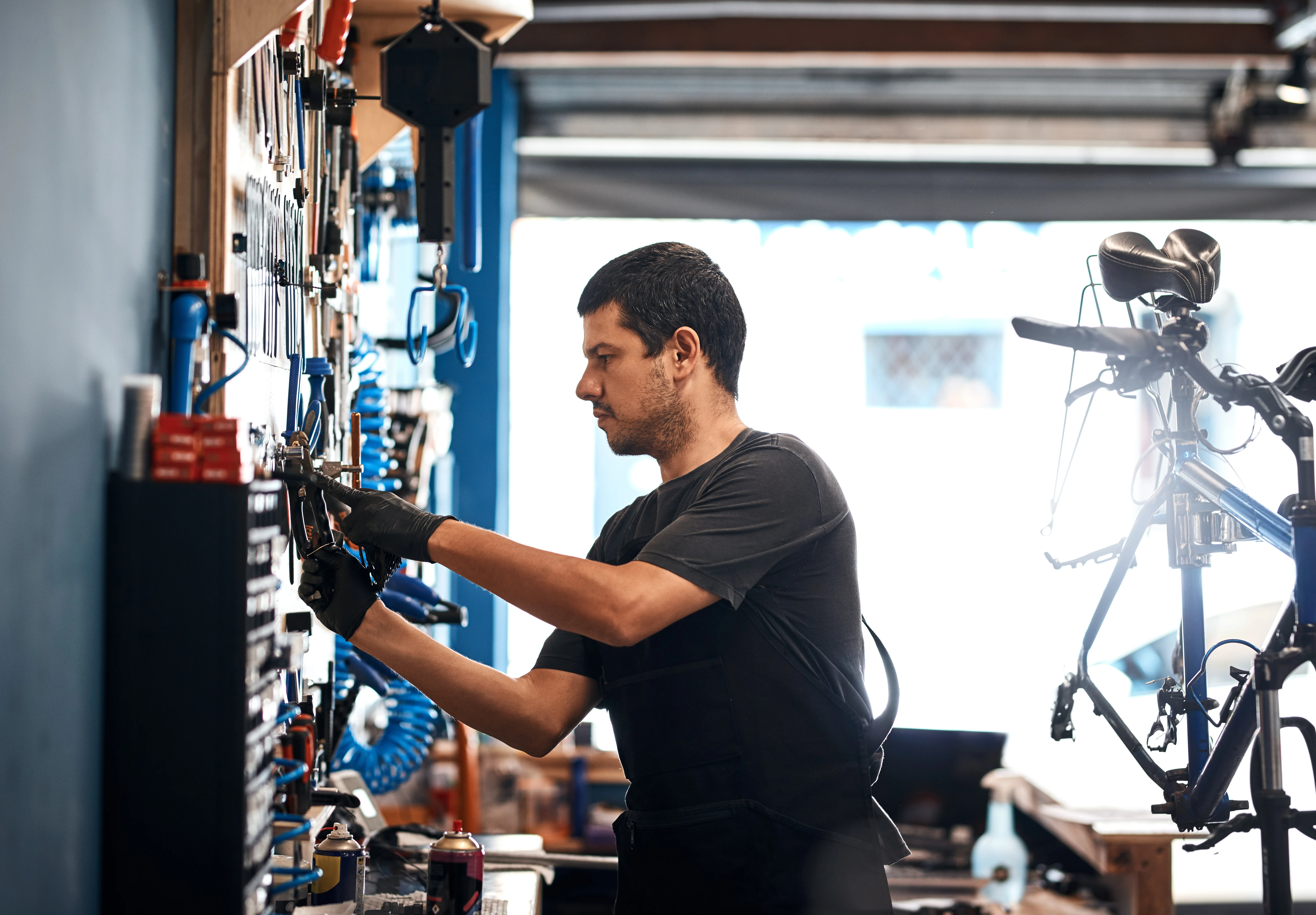 A mechanic repairing a bike at the workshop bench