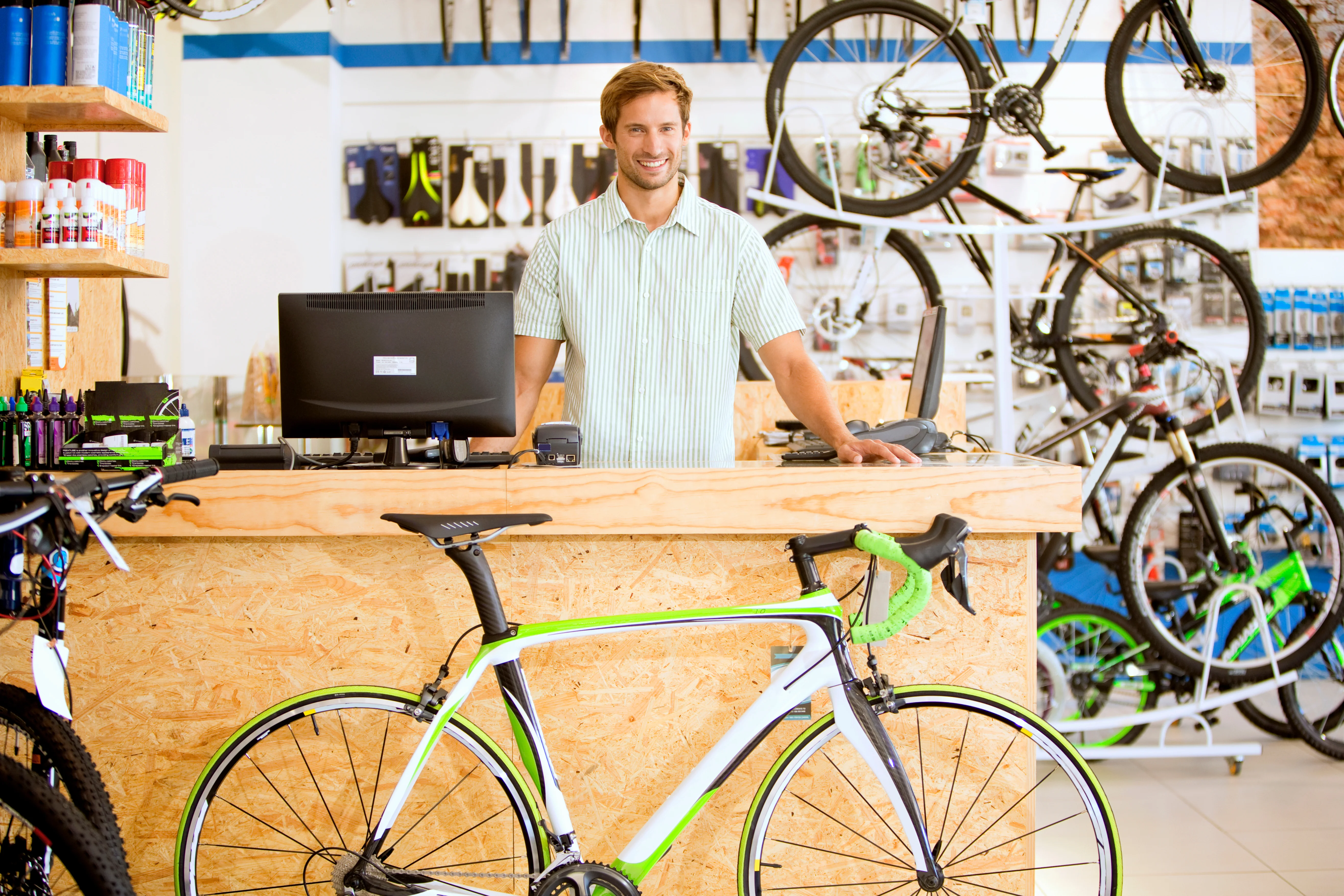 A store manager behind the counter of a bike shop