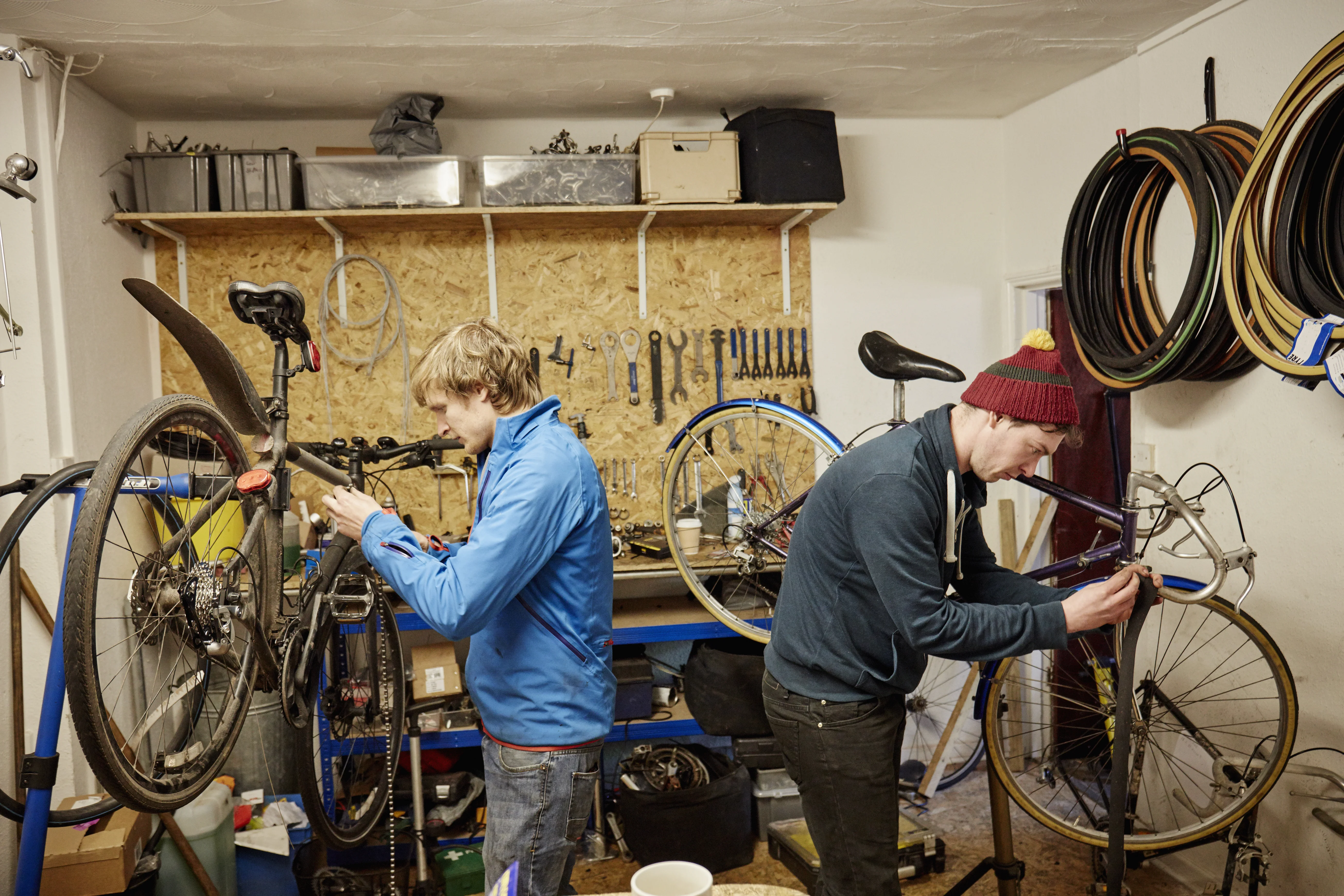 A customer and shop staff talking at the counter of a bike shop